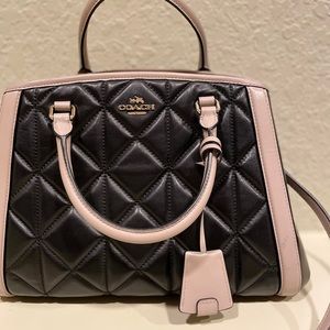 Cute black and white coach purse.